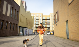 Simple Life London resident walking dog near apartment