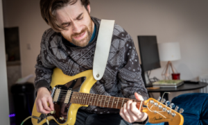 Simple Life London resident playing guitar